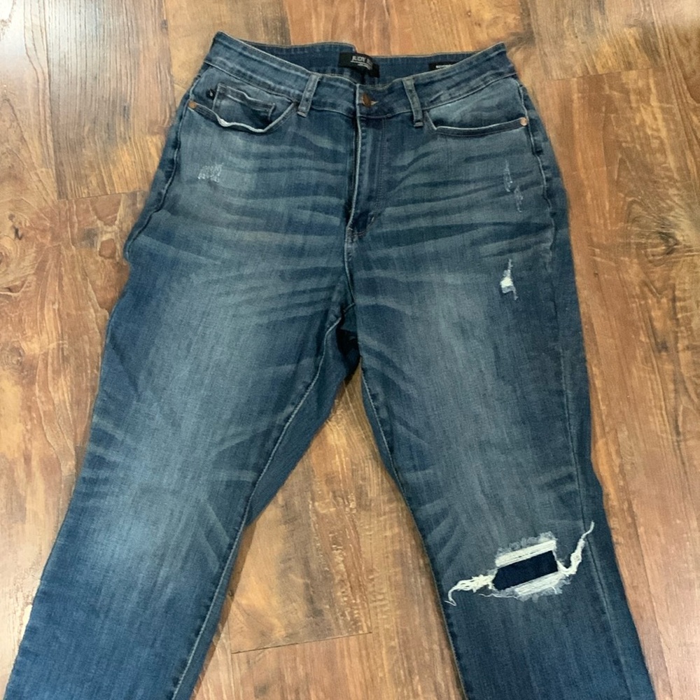 Judy Blue denim. Some distressing BUT it’s patched (came this way).